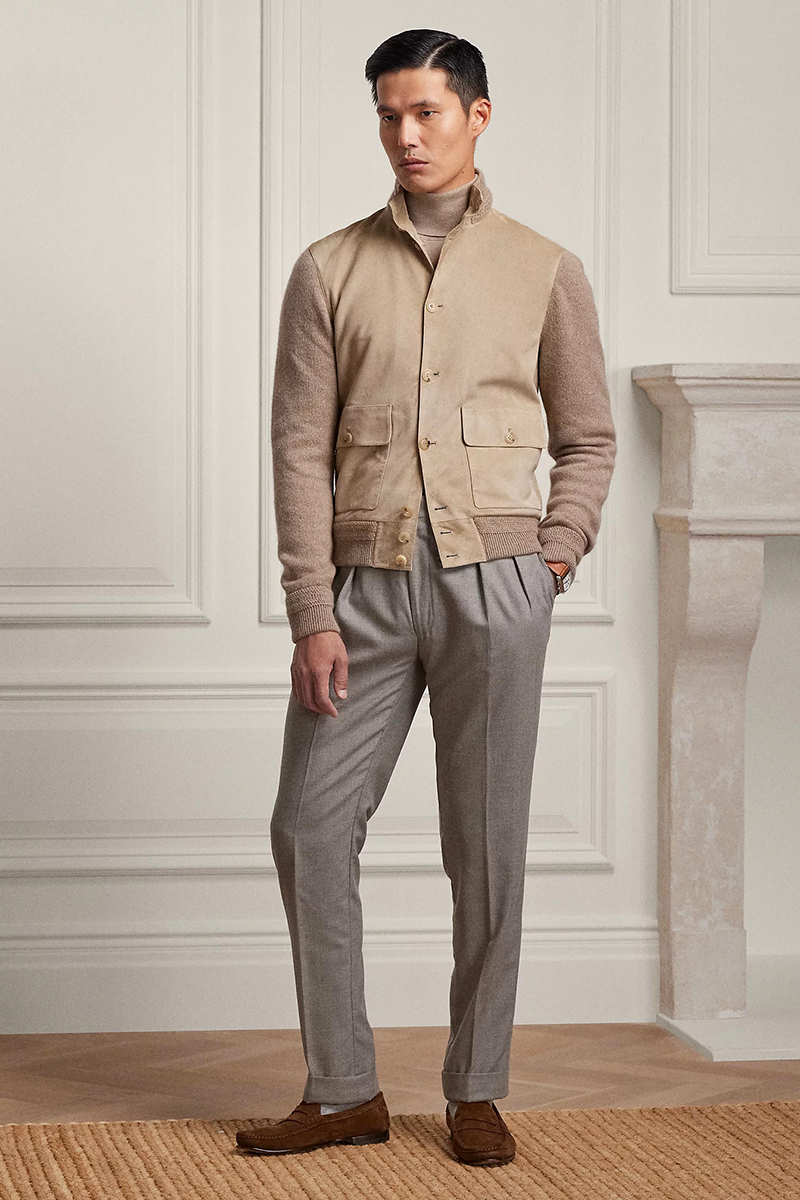 Wearing a beige jacket, beige turtleneck, gray pleated trousers, and brown penny loafers
