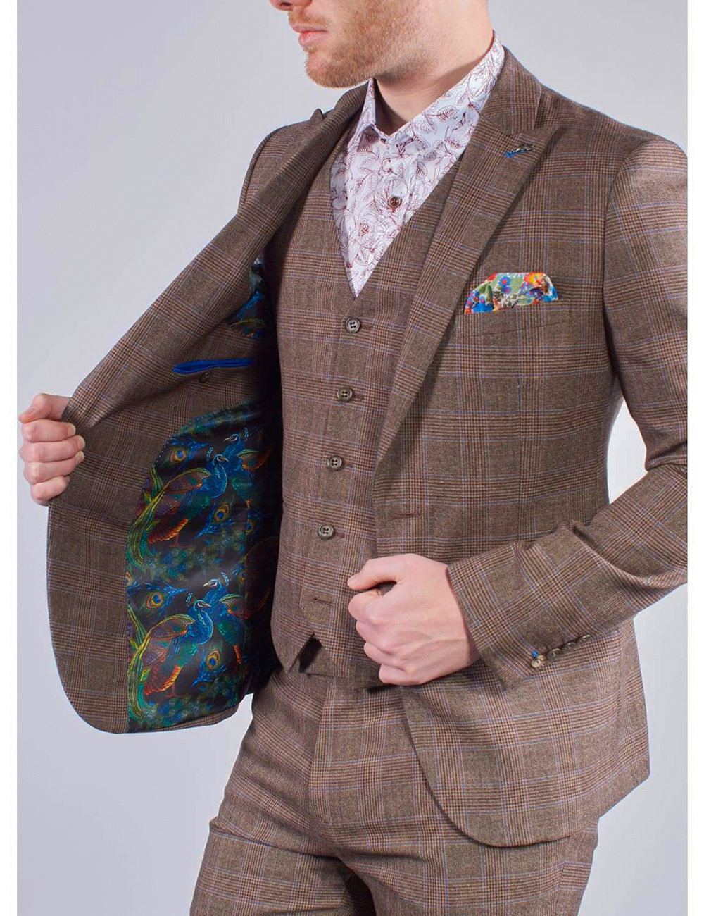 Wearing a brown wool suit, floral shirt, colorful pocket square