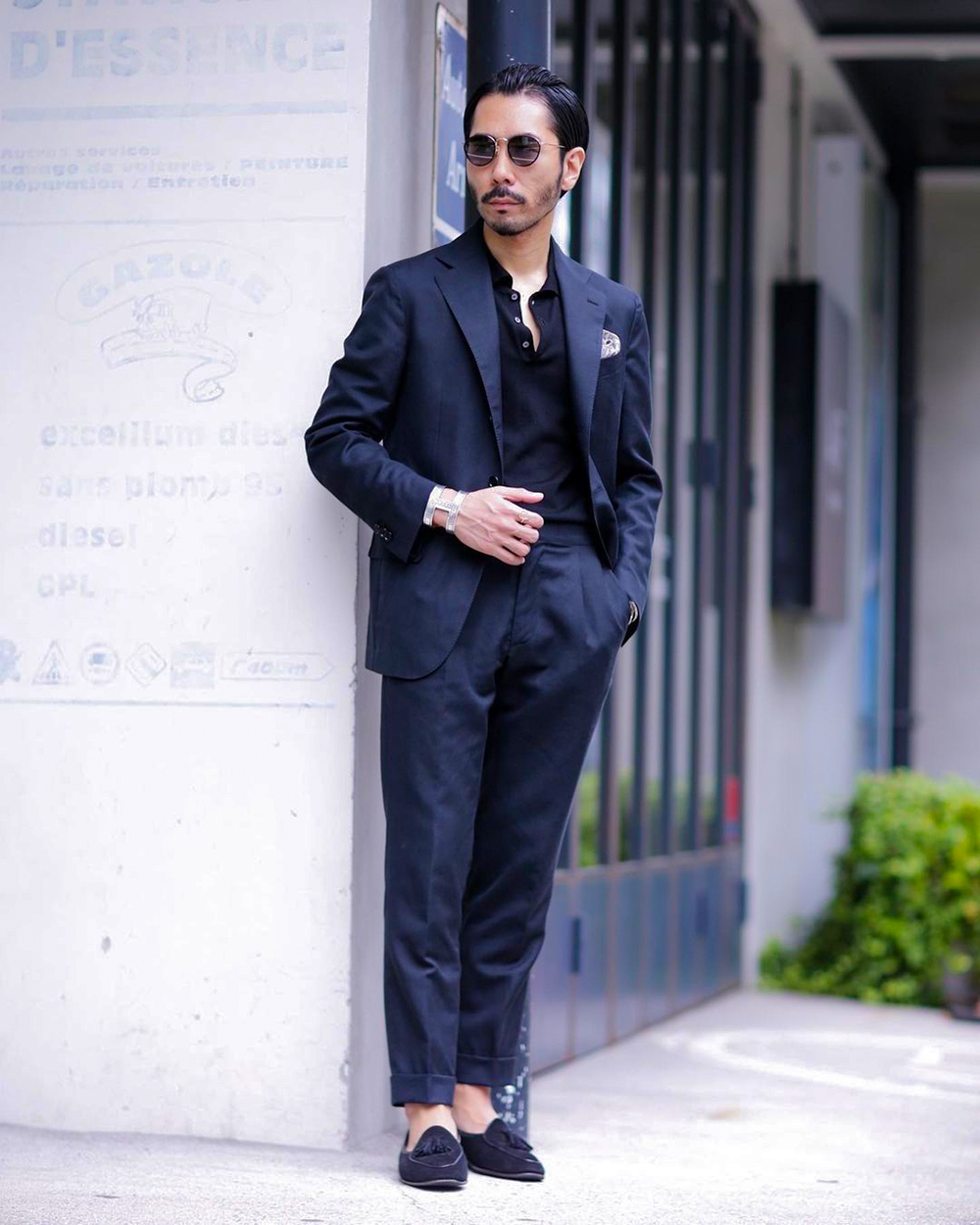 Wearing navy suit, black polo, and tassel loafers