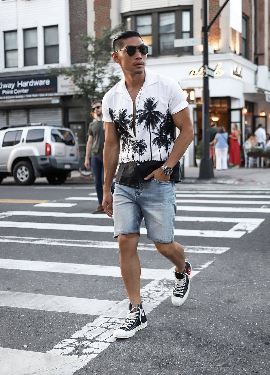 White and black short sleeve shirt, blue denim shorts, and black high top sneakers outfit