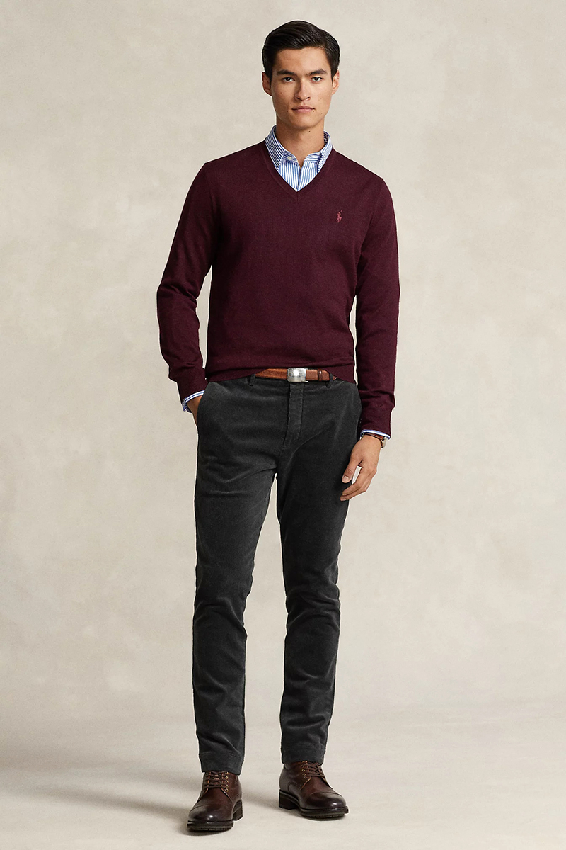 White and blue striped dress shirt, burgundy v neck sweater, charcoal gray corduroy trousers, and dark brown lace-up boots outfit