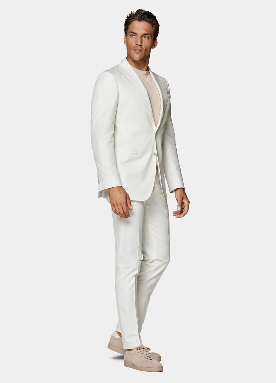 White linen suit, cream t-shirt, and tan sneakers outfit