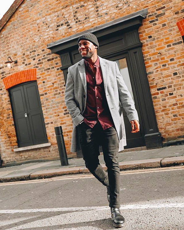 White overcoat, burgundy long sleeve shirt, black jeans, black Chelsea boots outfit