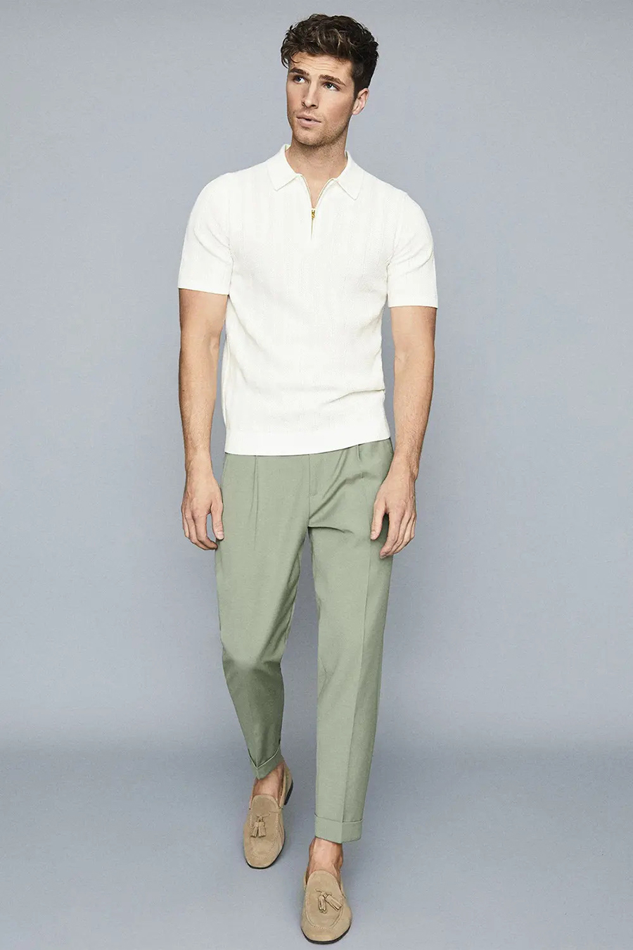 White polo shirt, green dress pants, and tan loafers outfit
