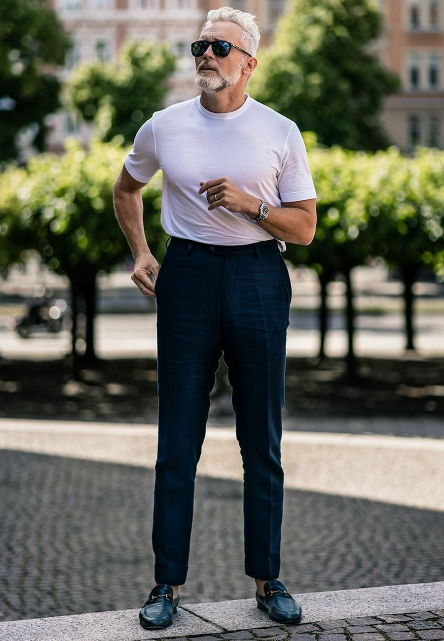 White t-shirt, navy dress pants, and navy horse bit loafers outfit